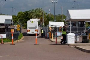 entrance and bus driving into quarantine camp Australia