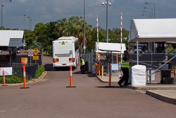 entrance and bus driving into quarantine camp Australia