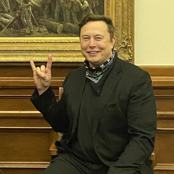 Elon Musk making devil's horn hand sign