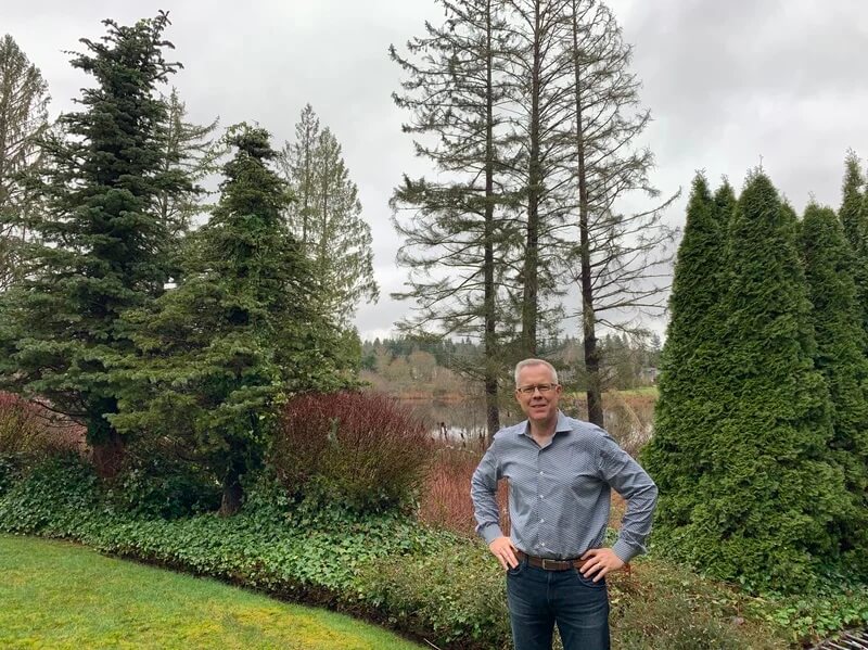 Freemason and Epik CEO Rob Monster standing in the backyard of his home in Sammamish, Washington