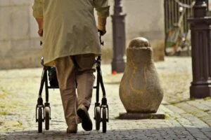 Old man with a rollator in the streets