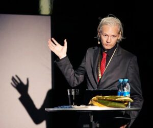 Freemason Julian Assange showing the M sign of Freemasonry or the Masons